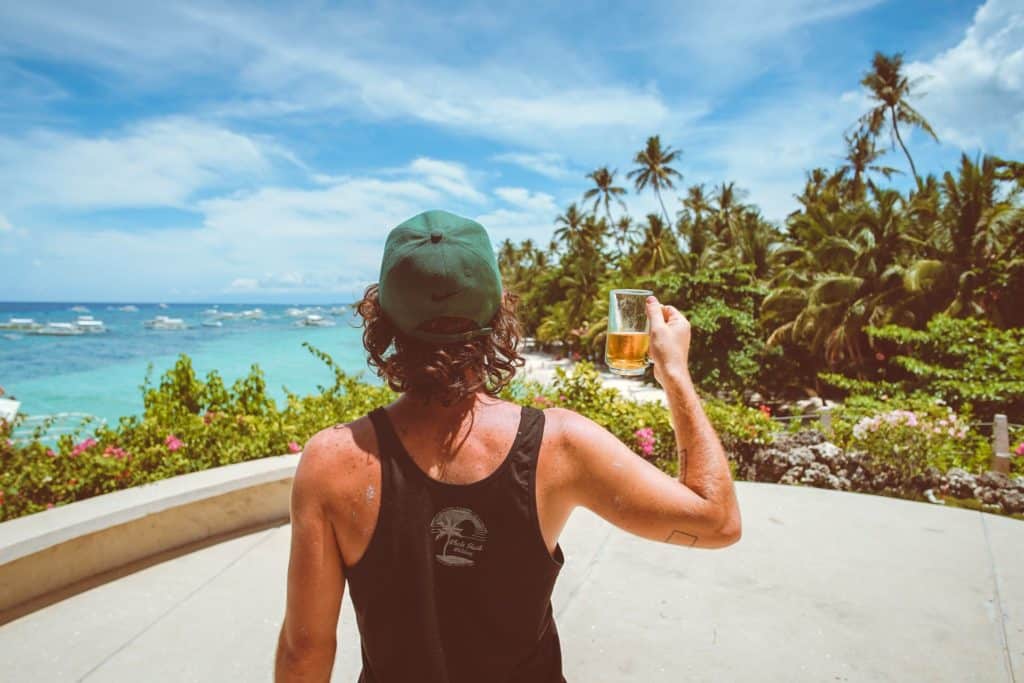 Man drinking a beer at a surf camp