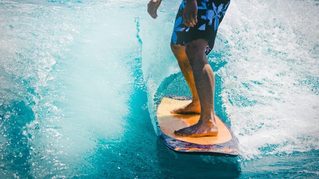 An image of a man surfing in bali wearing shorts