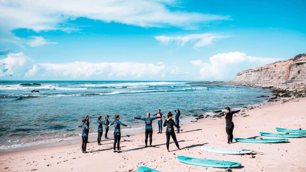 An image of a surfing lesson on the beach in Ericeira